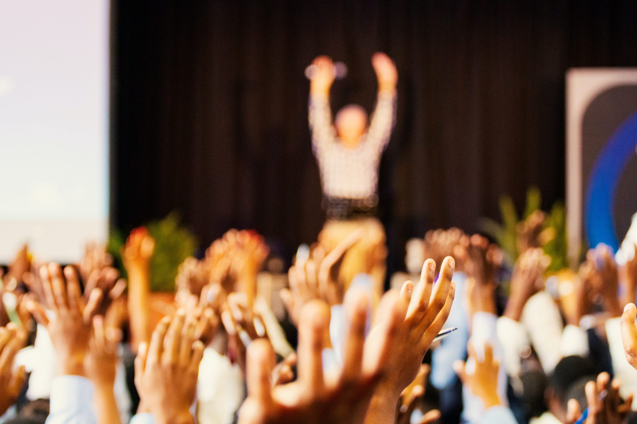 Hands raised at a convention