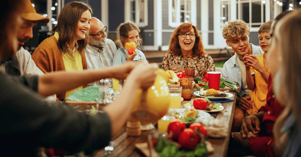 Happy family sharing a meal around the table.