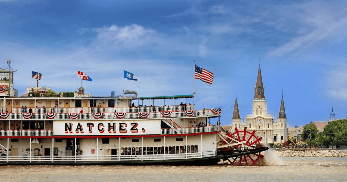 GroupSync | New Orleans for Group Travel | Steamboat Natchez paddlewheel boat on the Mississippi River on a sunny day