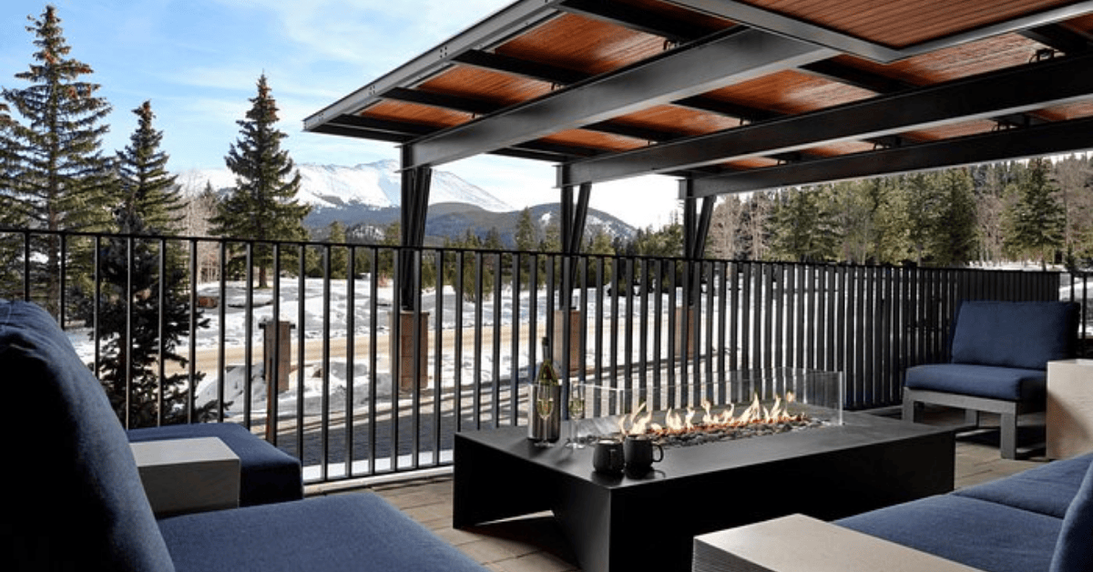 Outdoor living room with firepit in the snow-covered mountains