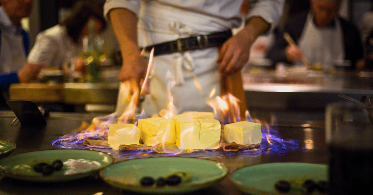 Chef cooking a flaming dish table-side