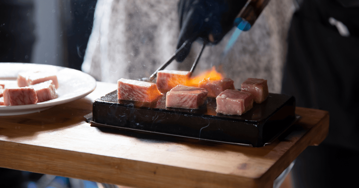 Cooking meat by blowtorch 
