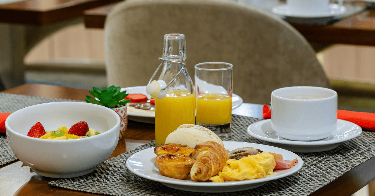 Colorful breakfast plate with a cup of coffee on the table at a restaurant