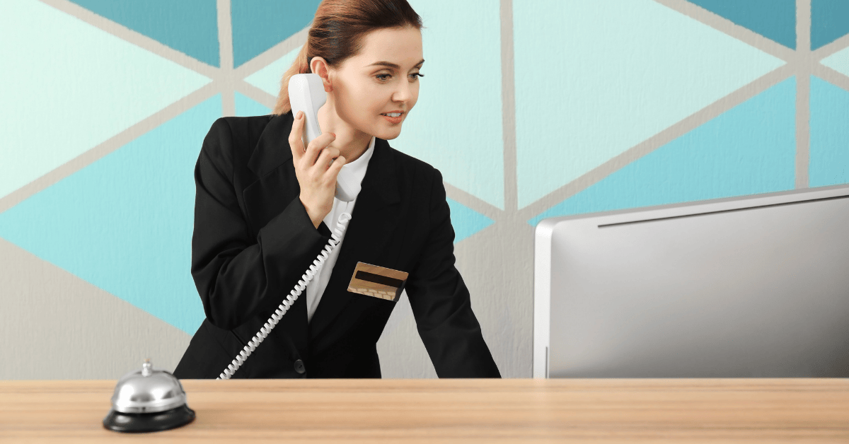 Fast Accurate RFP Responses - 1200x628 Hotel receptionist on the phone and searching on computer