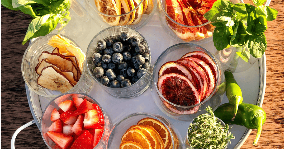 Close up of fruit and herbs on a garnish station