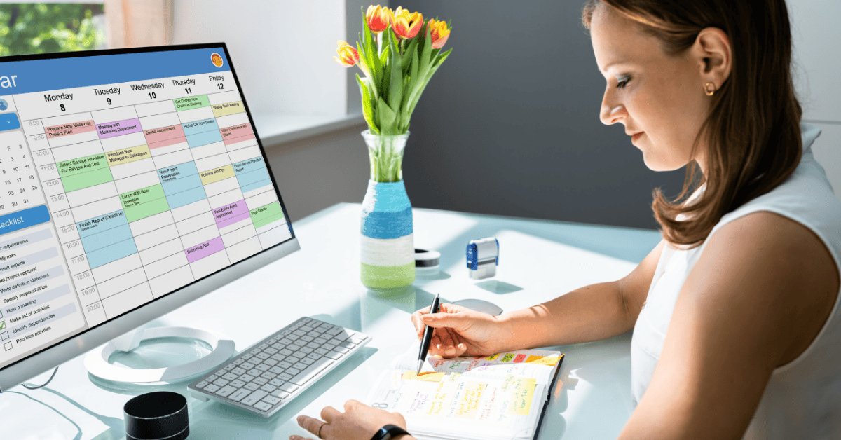RFP Timing - 1200x628 Woman at desk comparing calendars