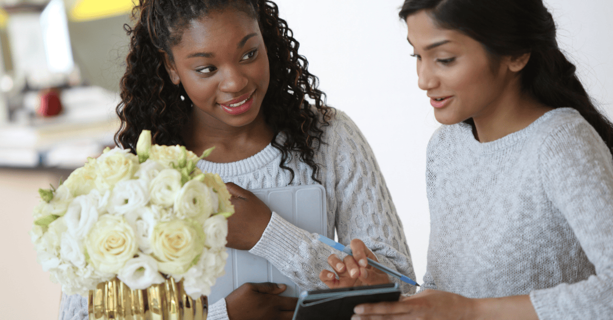 Two women reviewing notes