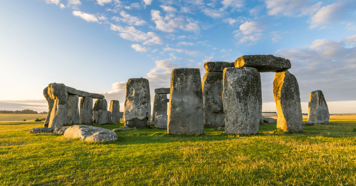 Stonehenge on a sunny day with blue skies and green grass