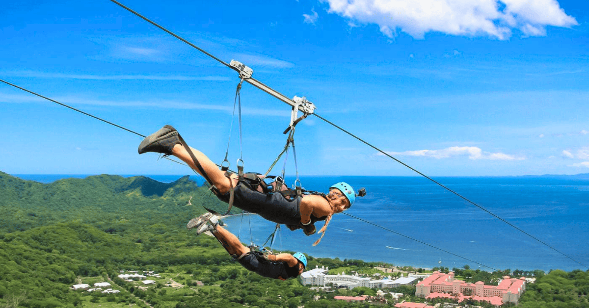Zip liners in Guanacaste Costa Rica enjoying views of lush green mountains and blue ocean