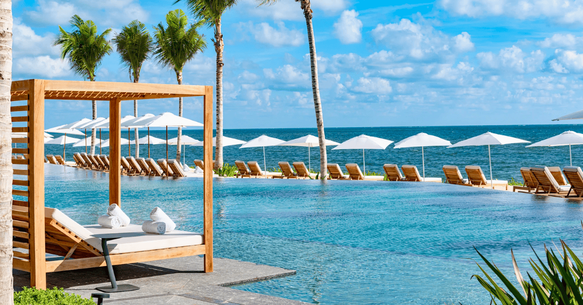 Cabana overlooking a calm hotel pool on the beach in Cancún Mexico