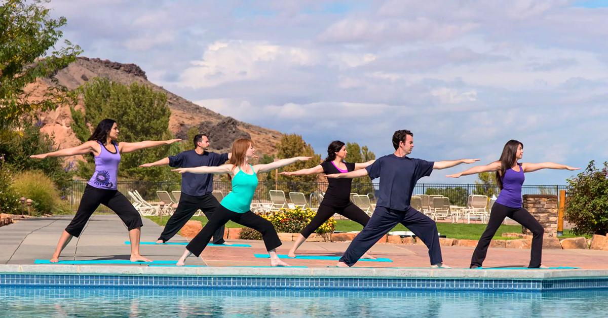 Hyatt Regency Tamaya Resort and Spa group doing yoga outside in front of pool