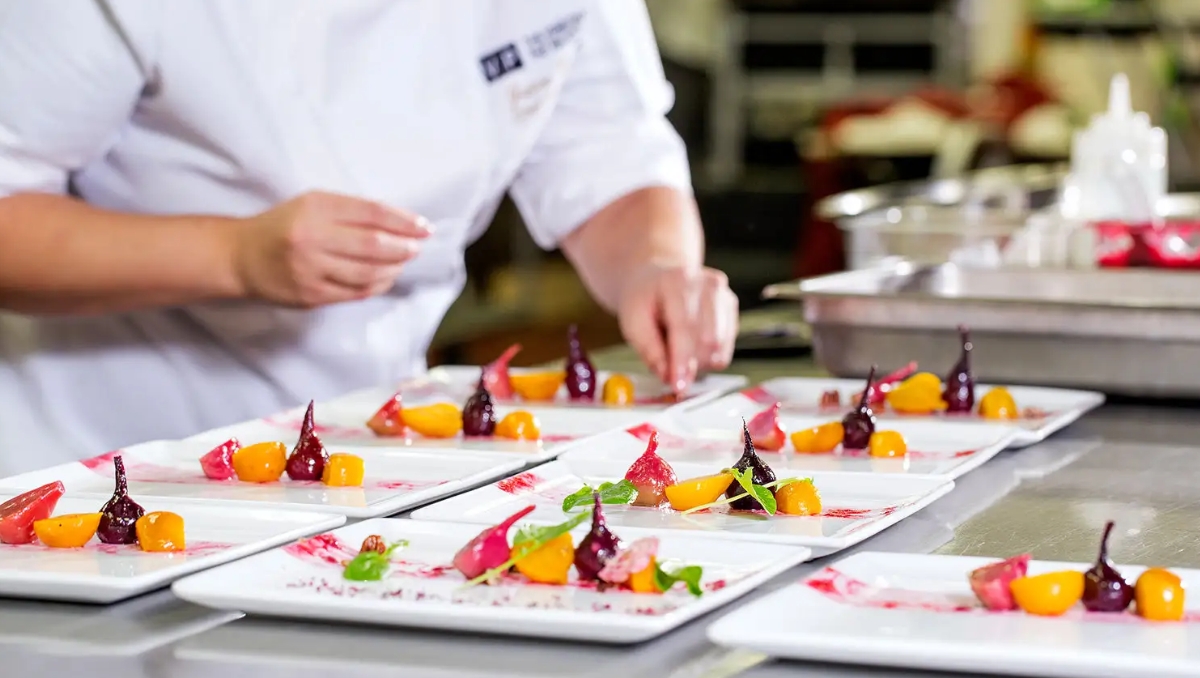 closeup of chef plating food