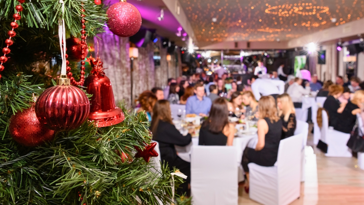 Christmas holiday trends party corporate event with decorated tree in foreground
